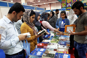  Photo of workers looking at Pathfinder display at book fair 